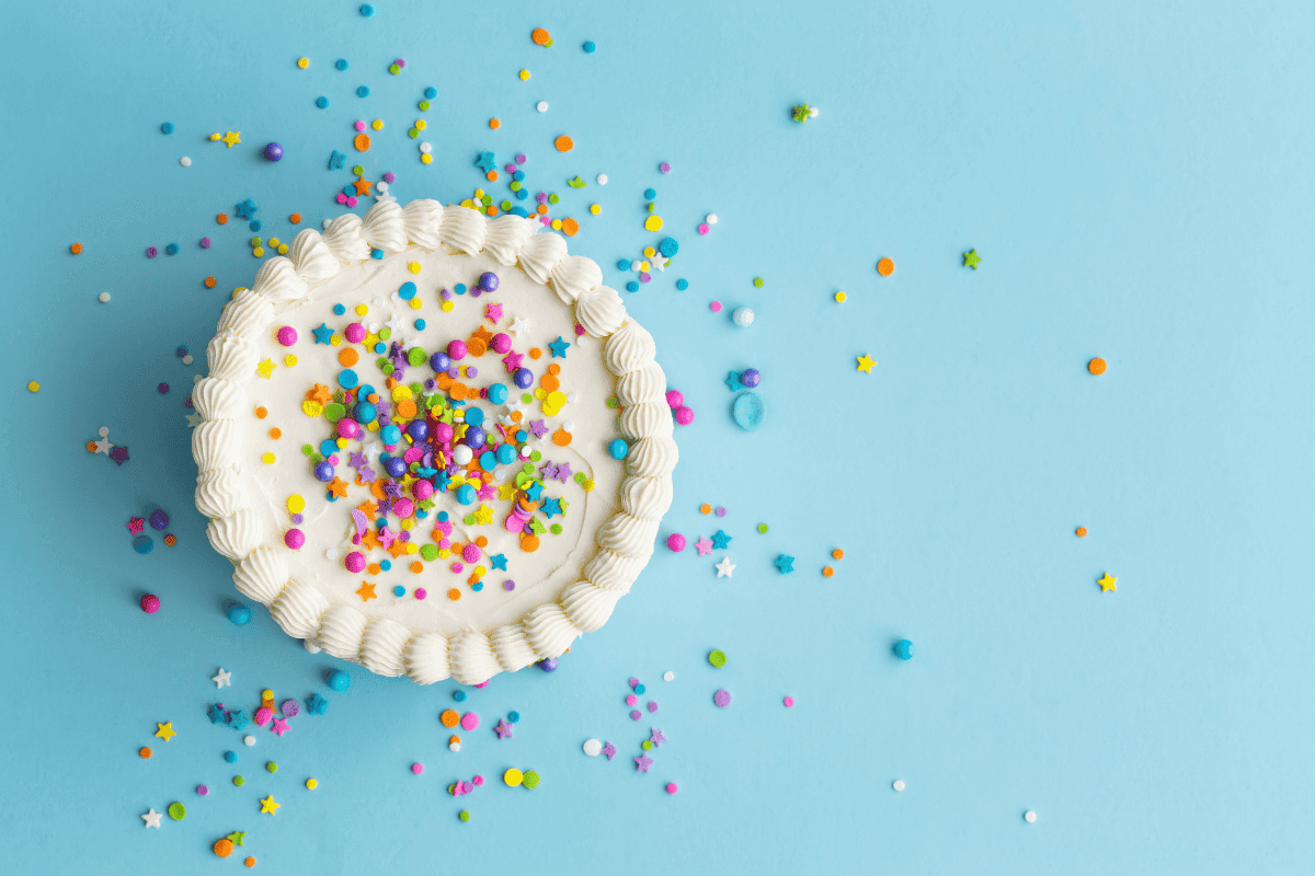 white cake with colourful sprinkles on top